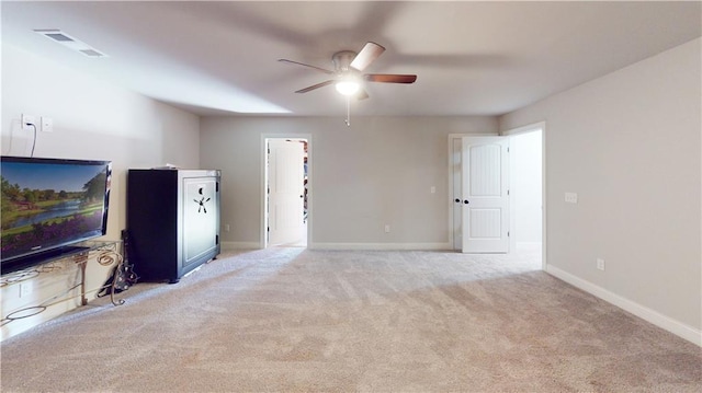 unfurnished living room featuring light carpet and ceiling fan