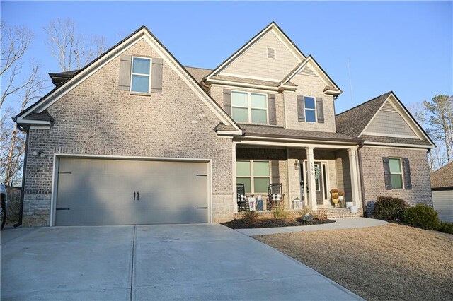 craftsman house featuring a porch, concrete driveway, and brick siding