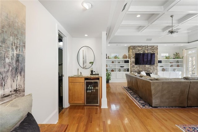 101 Terrace Dr, Atlanta, GA 30305 - living area with wine cooler, light wood-style flooring, beam ceiling, a ceiling fan, and a fireplace