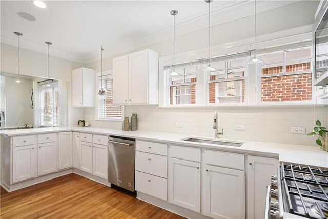 101 Terrace Dr, Atlanta, GA 30305 - kitchen featuring a sink, appliances with stainless steel finishes, crown molding, white cabinetry, and light wood-style flooring