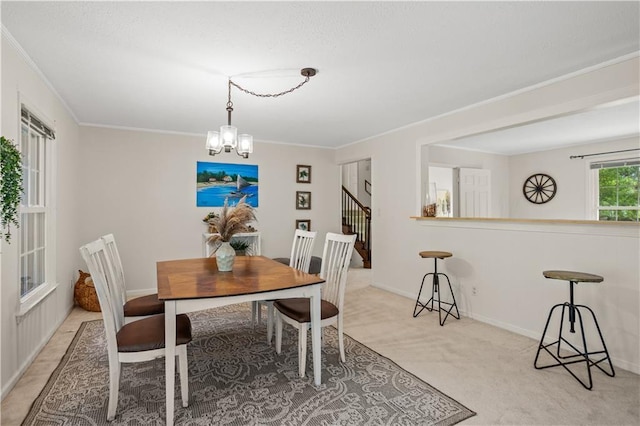 2621 Pass Cir, Gainesville, GA 30506 - dining room featuring a chandelier, ornamental molding, light colored carpet, baseboards, and stairs