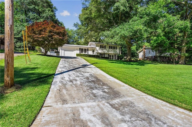 2621 Pass Cir, Gainesville, GA 30506 - split level home with concrete driveway, a front lawn, and an attached garage