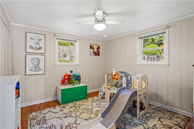 2621 Pass Cir, Gainesville, GA 30506 - playroom with healthy amount of natural light, wood finished floors, a ceiling fan, baseboards, and crown molding