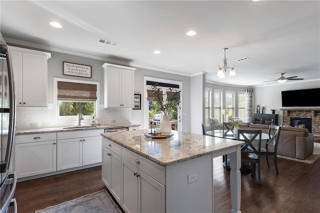 5240 Bristlecone Pine Way, Cumming, GA 30040 - kitchen with ornamental molding, open floor plan, white cabinets, dark wood-type flooring, and backsplash