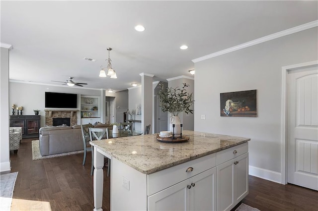 5240 Bristlecone Pine Way, Cumming, GA 30040 - kitchen with a ceiling fan, crown molding, white cabinetry, dark wood finished floors, and pendant lighting