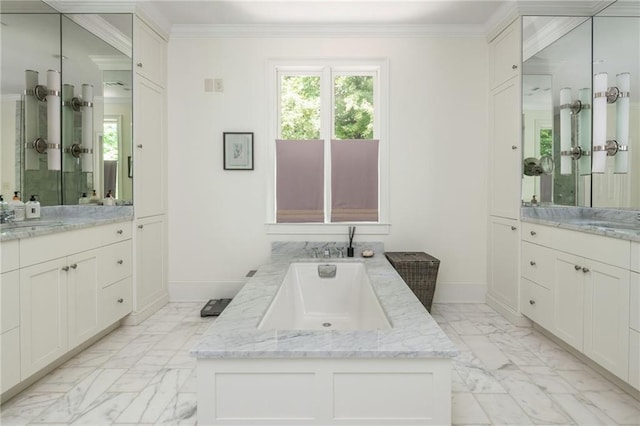 bathroom featuring marble finish flooring, baseboards, a tub, two vanities, and ornamental molding