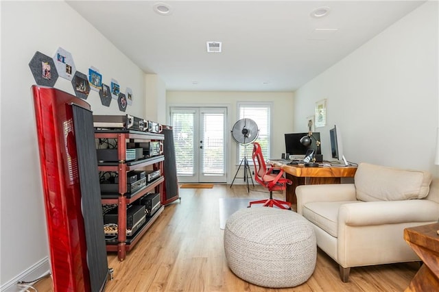 home office with light wood finished floors, french doors, and recessed lighting