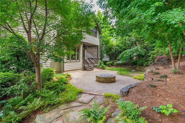 view of yard featuring an outdoor fire pit and a patio area