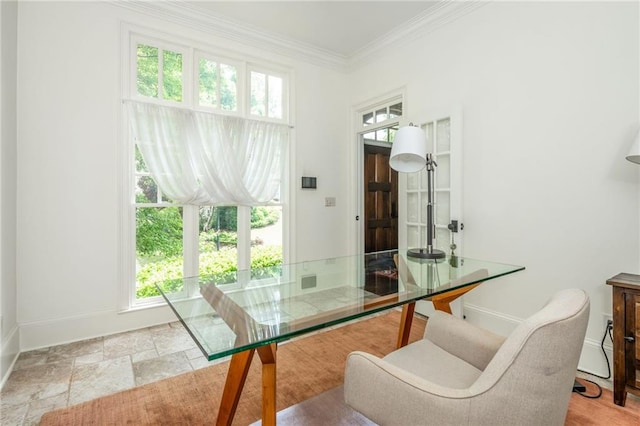 dining space with baseboards and crown molding