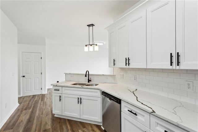 kitchen with decorative light fixtures, a sink, stainless steel dishwasher, and white cabinetry