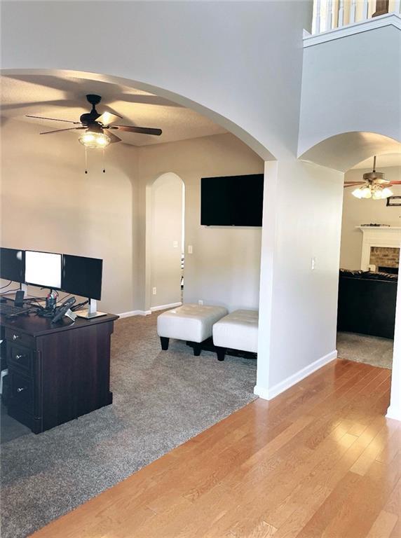 living room featuring hardwood / wood-style floors and ceiling fan