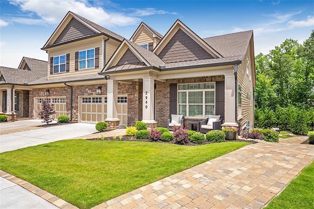 craftsman-style house featuring a garage and a front yard