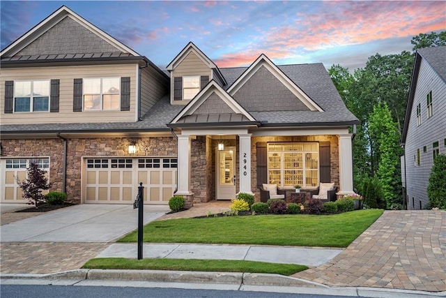 craftsman house featuring a yard and a garage