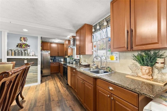 kitchen featuring stainless steel appliances, dark wood-type flooring, a sink, decorative backsplash, and brown cabinetry