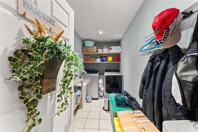 interior space featuring separate washer and dryer and light tile patterned flooring