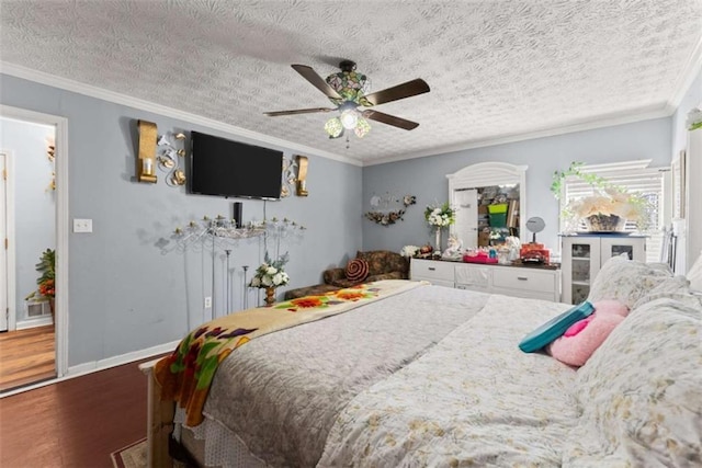 bedroom featuring a textured ceiling, baseboards, dark wood finished floors, and crown molding