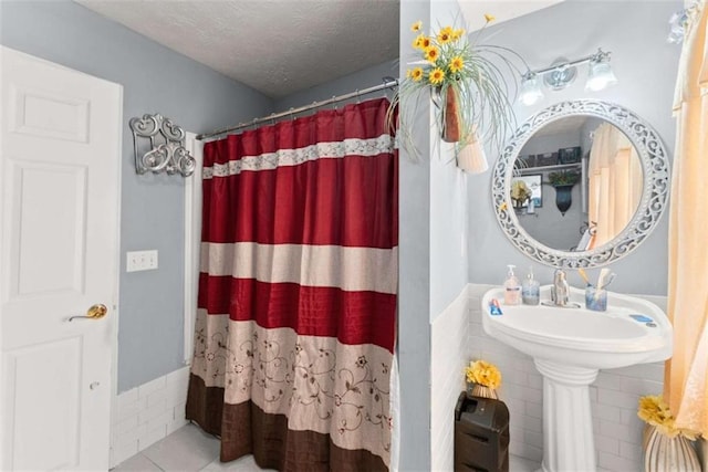 bathroom featuring tile patterned flooring and a textured ceiling