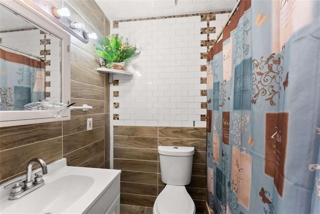 bathroom featuring a shower with shower curtain, tile walls, toilet, and vanity