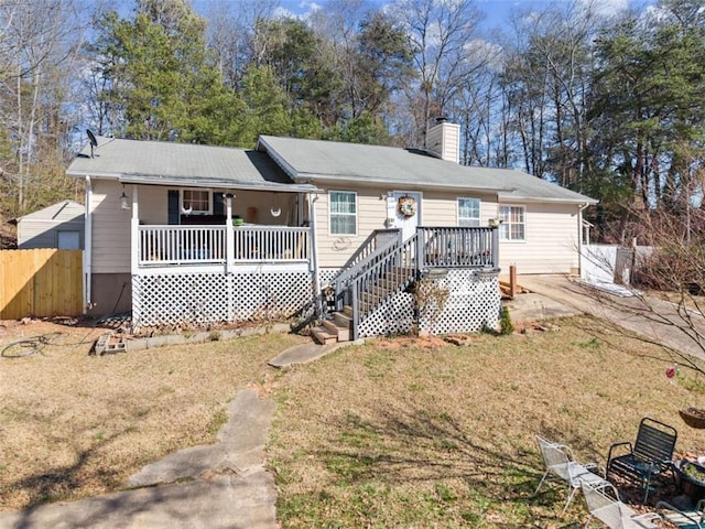 single story home featuring a chimney, a porch, stairs, fence, and a front lawn