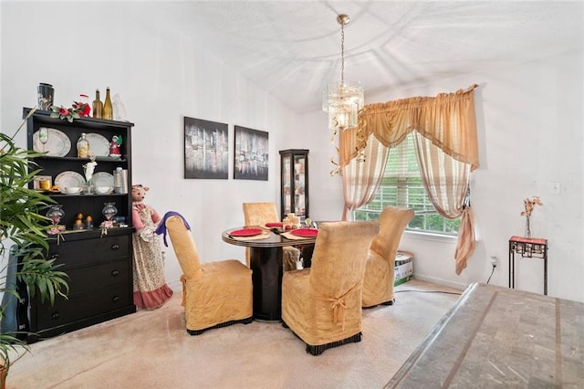 carpeted dining room with a chandelier