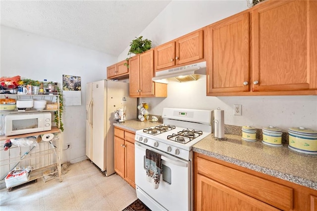 kitchen with white appliances, under cabinet range hood, lofted ceiling, light floors, and a textured ceiling
