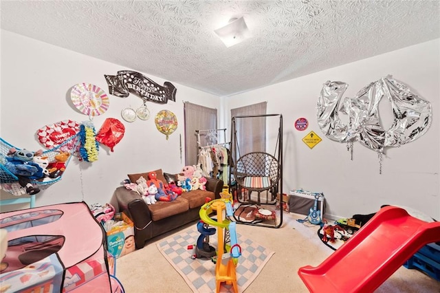 game room featuring a textured ceiling and carpet floors