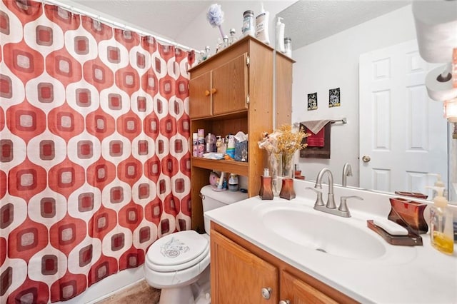bathroom with toilet, vanity, curtained shower, and a textured ceiling