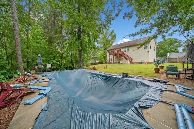 view of pool featuring stairway and a deck