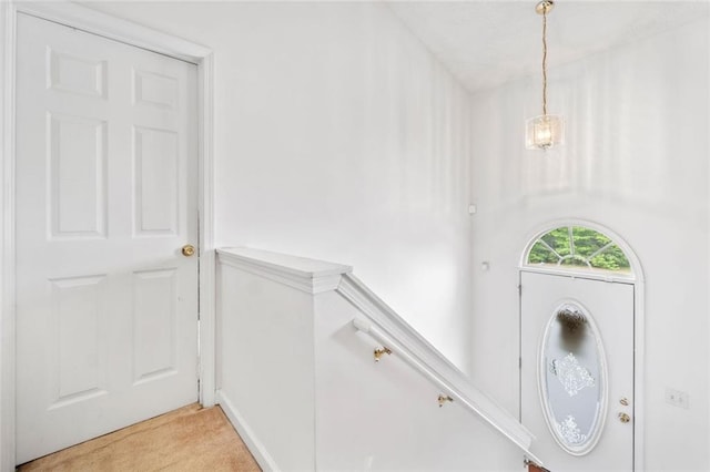 foyer entrance with light carpet