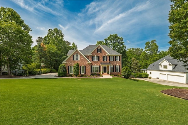 view of front of property with a front lawn, brick siding, and a garage