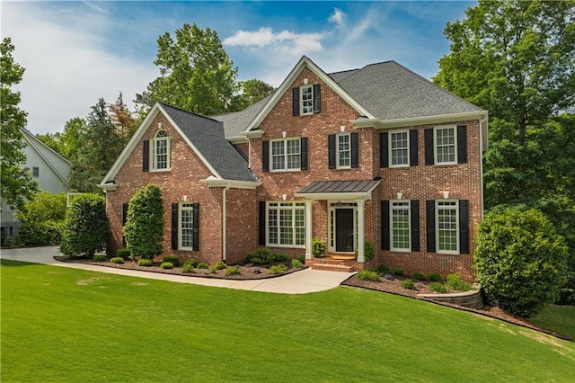 view of front of house with brick siding and a front lawn