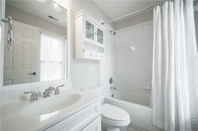 bathroom featuring shower / bath combination with curtain, toilet, and vanity