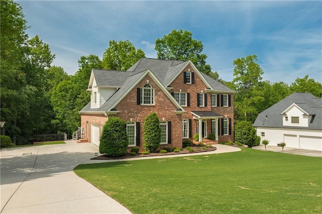 view of front of house featuring brick siding, a garage, concrete driveway, and a front yard