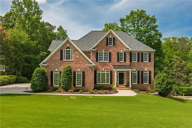 view of front of property with a front yard and brick siding