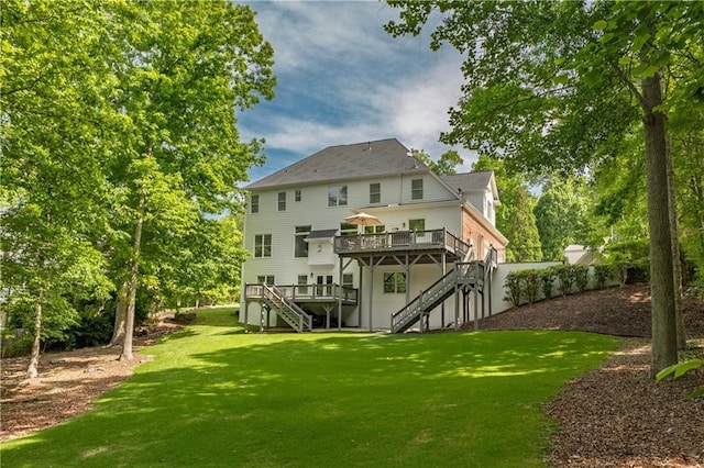 back of house with stairs, a deck, and a lawn