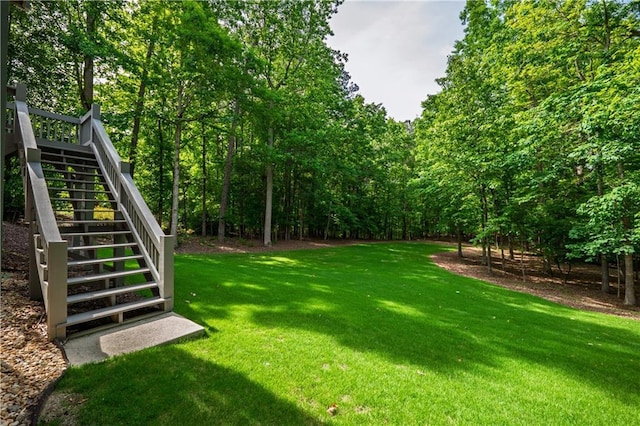 view of green lawn with stairs