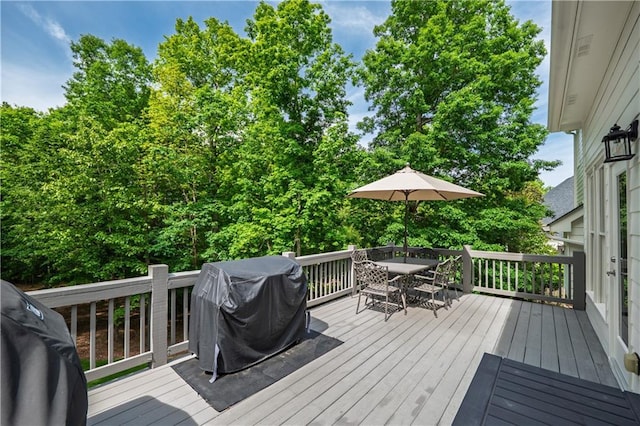 wooden deck featuring outdoor dining space and grilling area