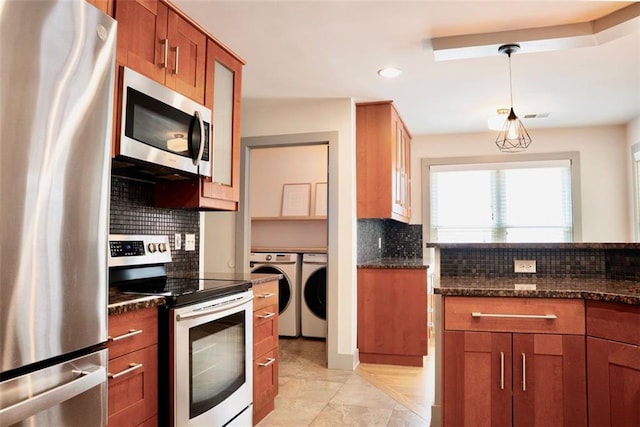 3050 Baymount Dr, Lawrenceville, GA 30043 - kitchen featuring stainless steel appliances, washing machine and clothes dryer, backsplash, brown cabinets, and recessed lighting