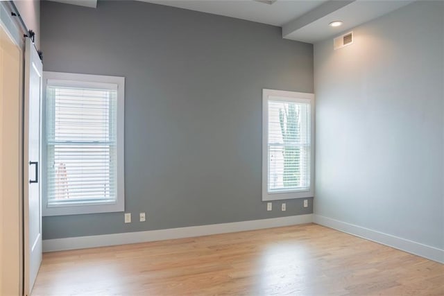 3050 Baymount Dr, Lawrenceville, GA 30043 - unfurnished room with wood finished floors, a barn door, and recessed lighting