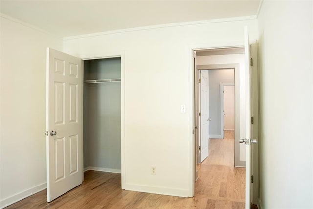 3050 Baymount Dr, Lawrenceville, GA 30043 - unfurnished bedroom with ornamental molding, light wood finished floors, and a closet