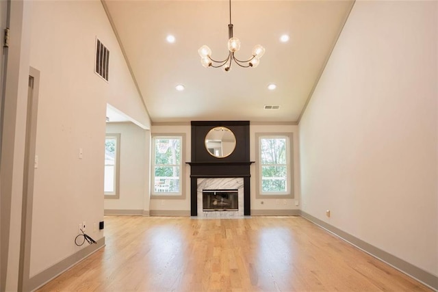 3050 Baymount Dr, Lawrenceville, GA 30043 - unfurnished living room with a chandelier, a premium fireplace, wood finished floors, recessed lighting, and crown molding
