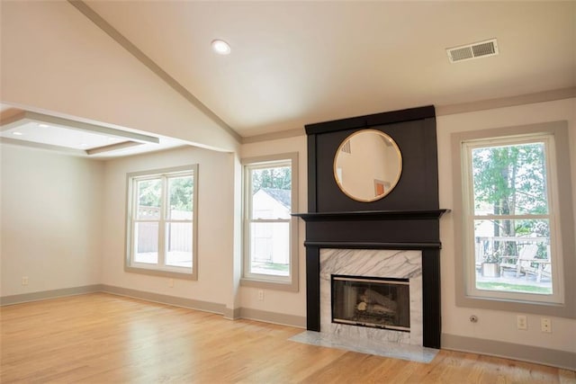 3050 Baymount Dr, Lawrenceville, GA 30043 - unfurnished living room featuring lofted ceiling, a high end fireplace, wood finished floors, and recessed lighting
