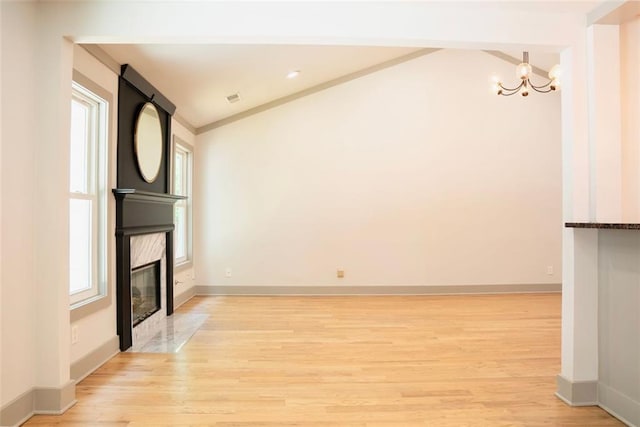 3050 Baymount Dr, Lawrenceville, GA 30043 - unfurnished living room featuring a chandelier, light wood finished floors, a premium fireplace, and crown molding
