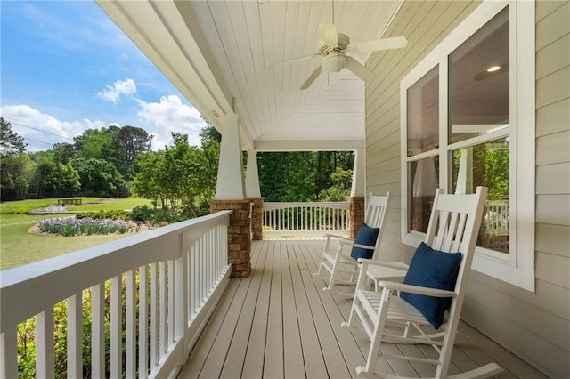 wooden terrace featuring ceiling fan and a porch
