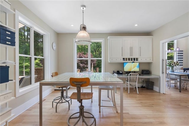 dining space with light wood-style floors and recessed lighting