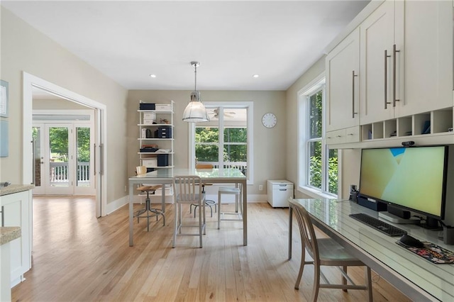 dining room with light wood-style floors, baseboards, and recessed lighting