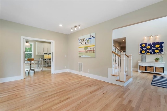 interior space featuring visible vents, stairway, baseboards, light wood-style floors, and recessed lighting