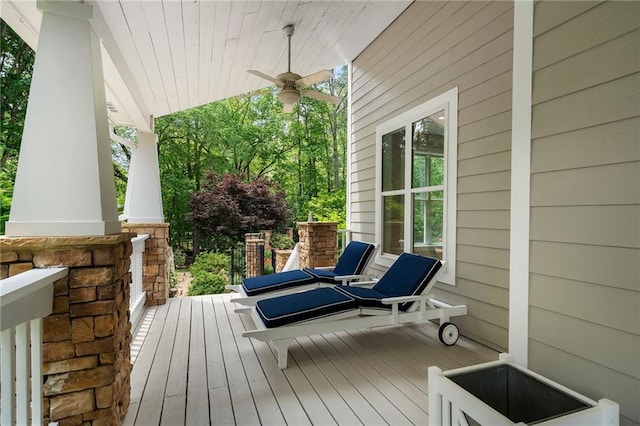 deck with covered porch and a ceiling fan