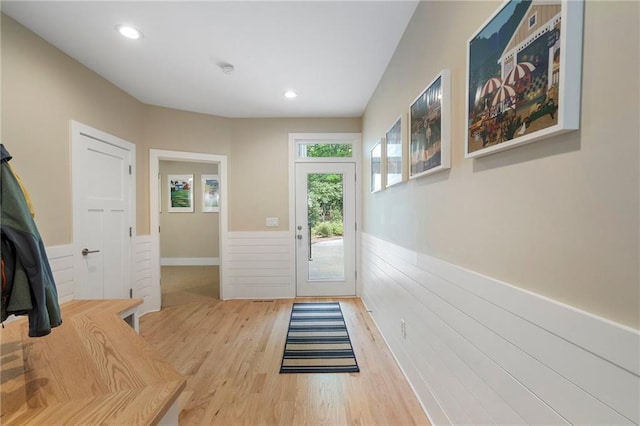entryway with recessed lighting, wainscoting, and wood finished floors