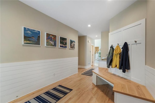 mudroom featuring light wood-style floors, a wainscoted wall, and recessed lighting